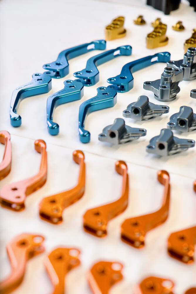 Blue and orange anodised aluminium components