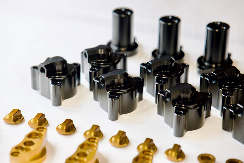 Hard anodised defence equipment components after metal finishing