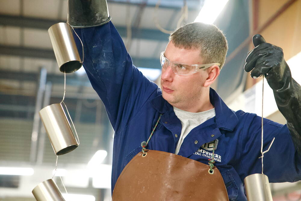HMC operator inspecting an anodised aluminium finish