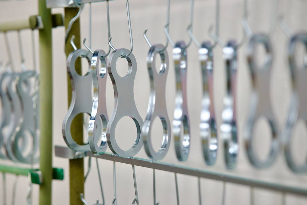 Zinc-plated brackets on a drying rack